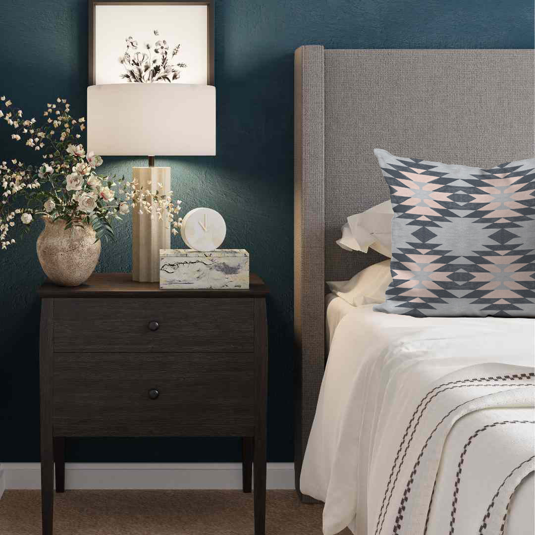 a bedroom with a bed, nightstand, and lamp