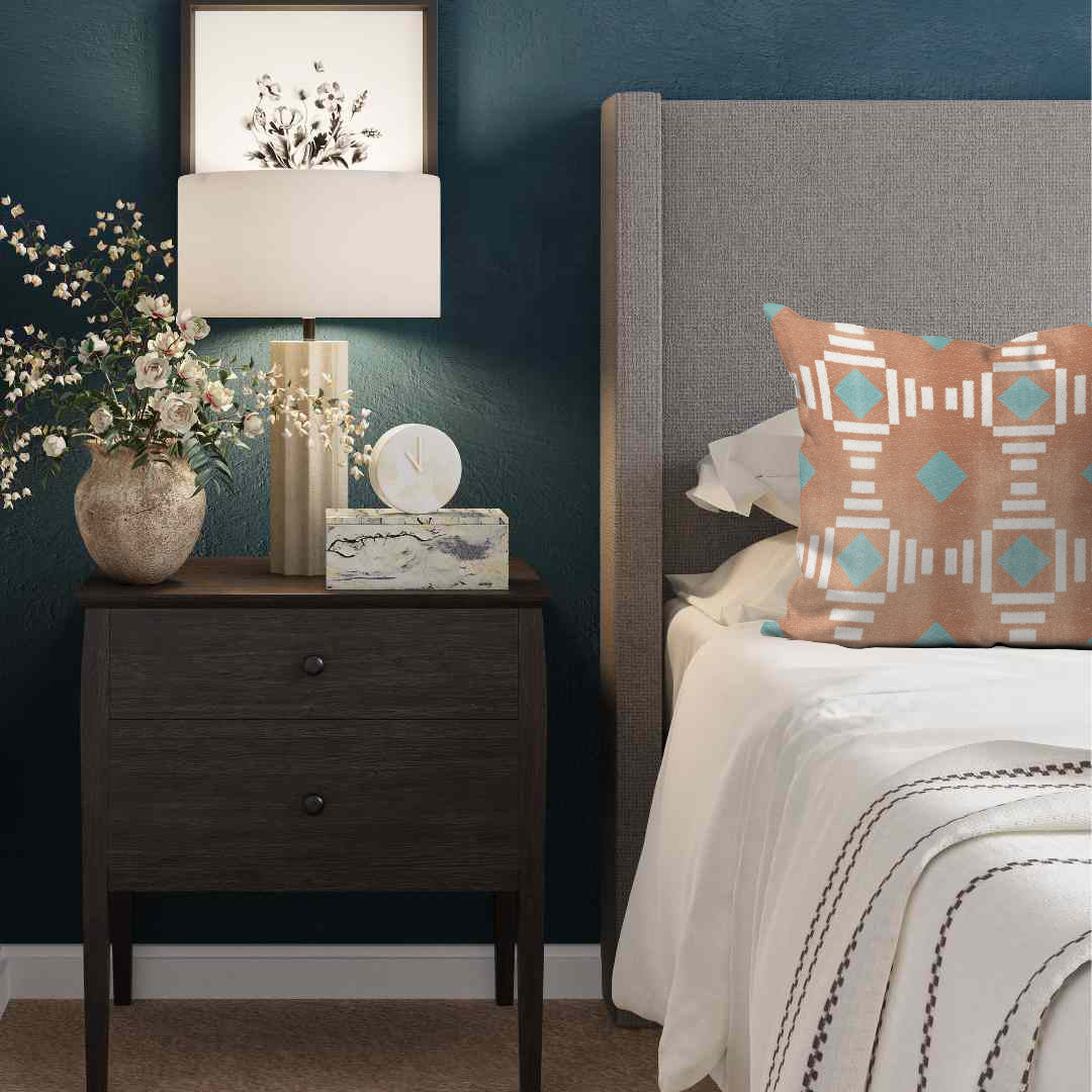 a bedroom with a bed, nightstand, and lamp