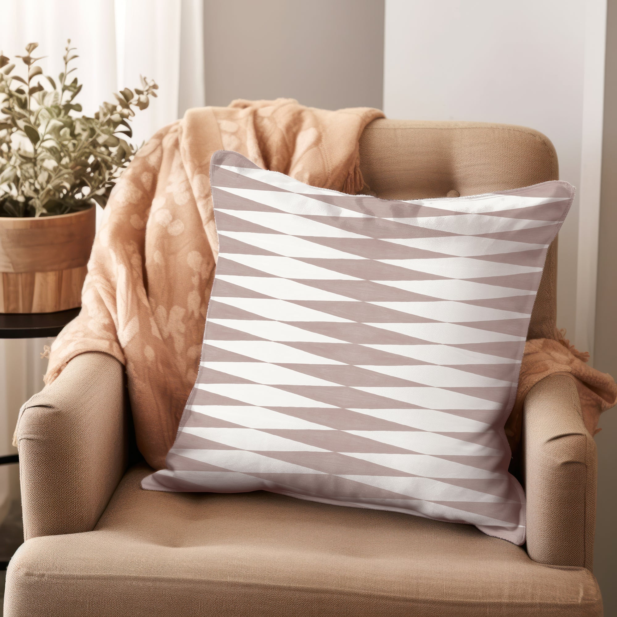 a chair with a pillow on top of it next to a potted plant