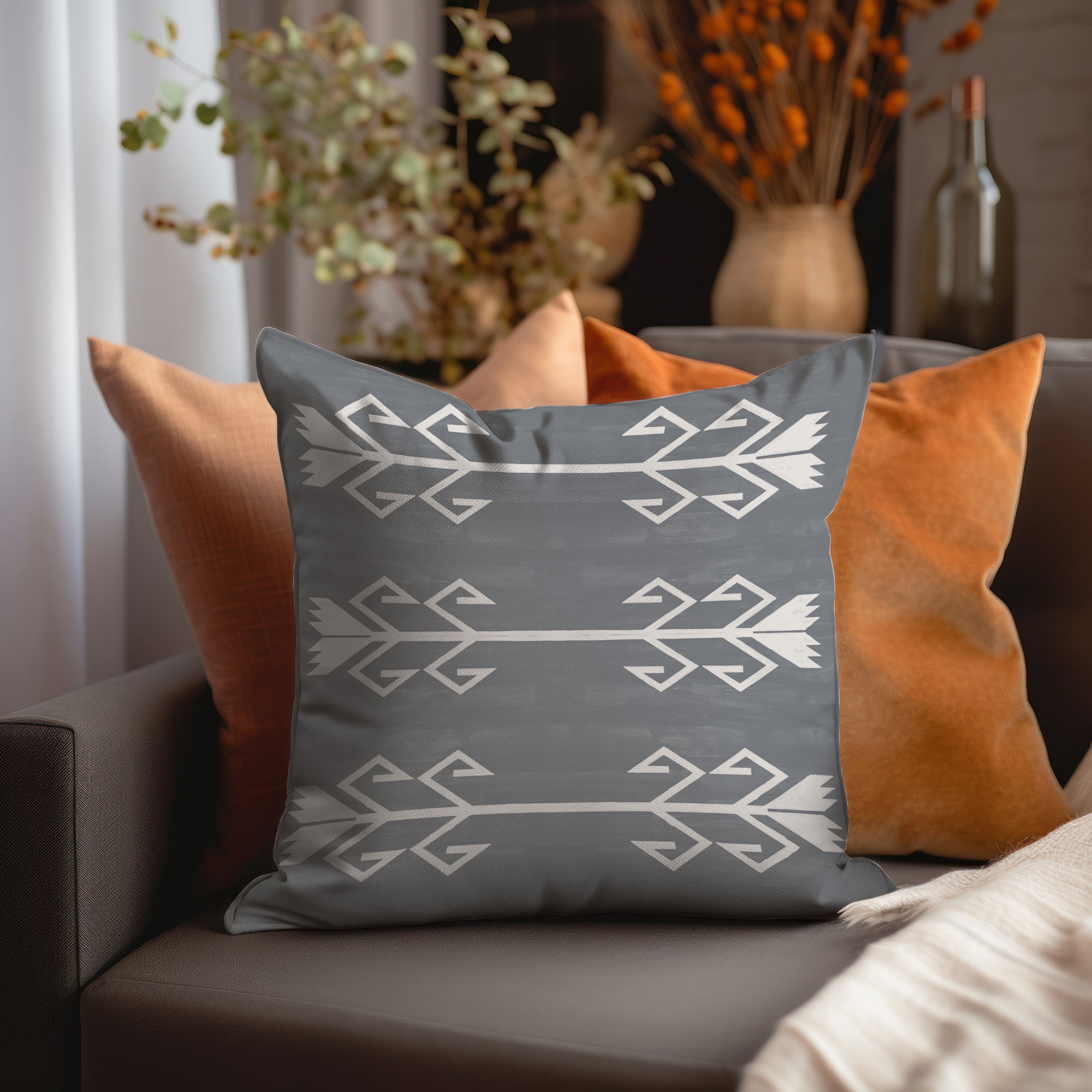 a gray and orange pillow sitting on top of a couch