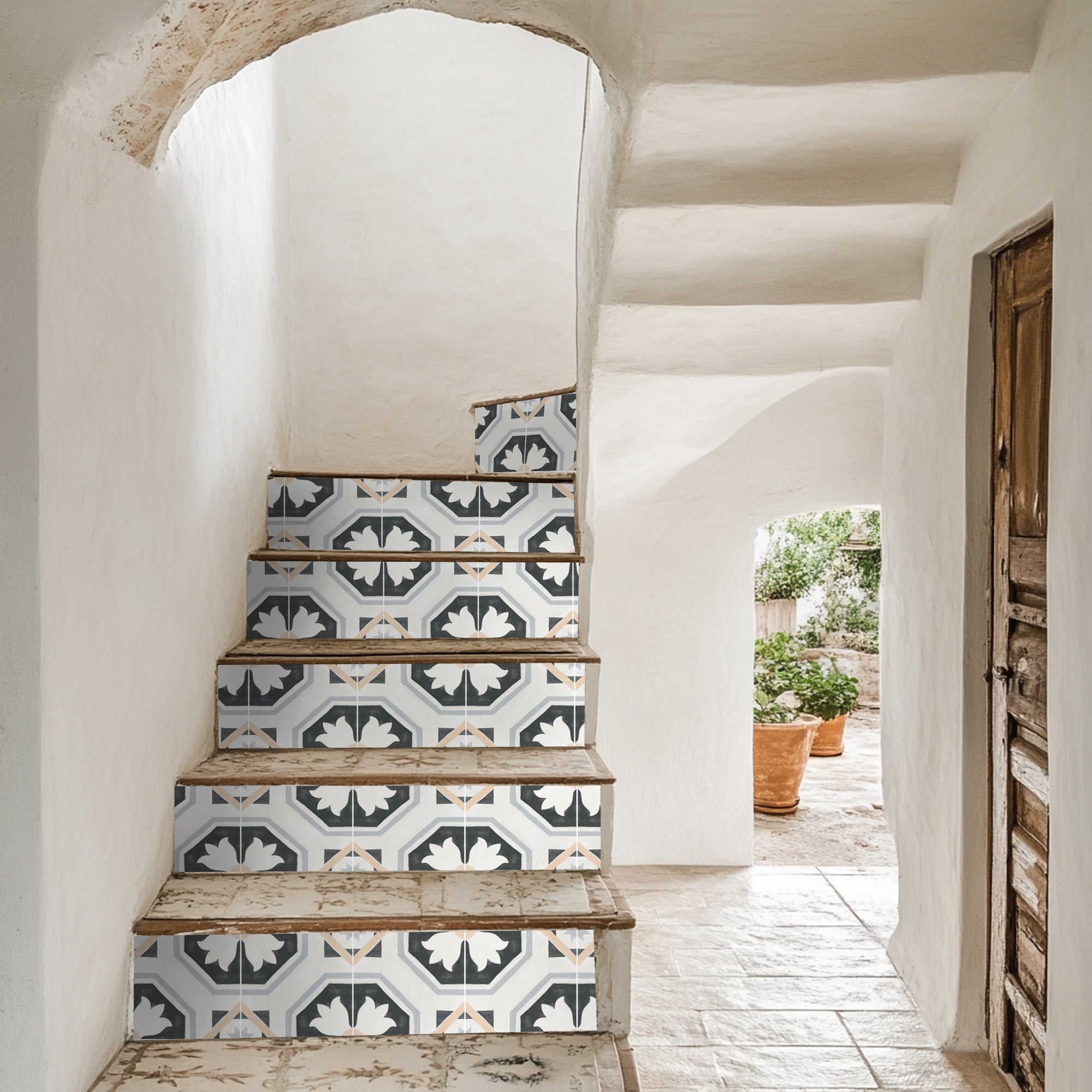 a set of stairs leading to a potted plant