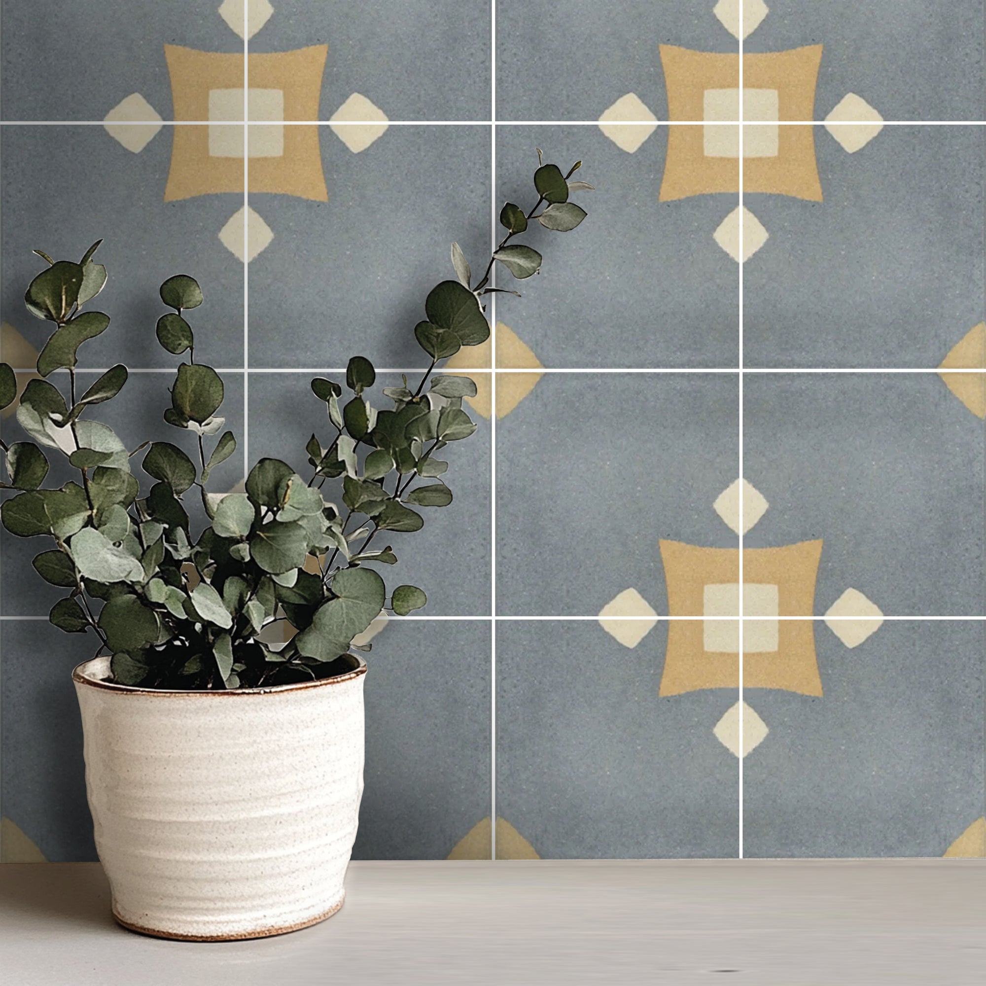 a potted plant sitting on a table in front of a tiled wall