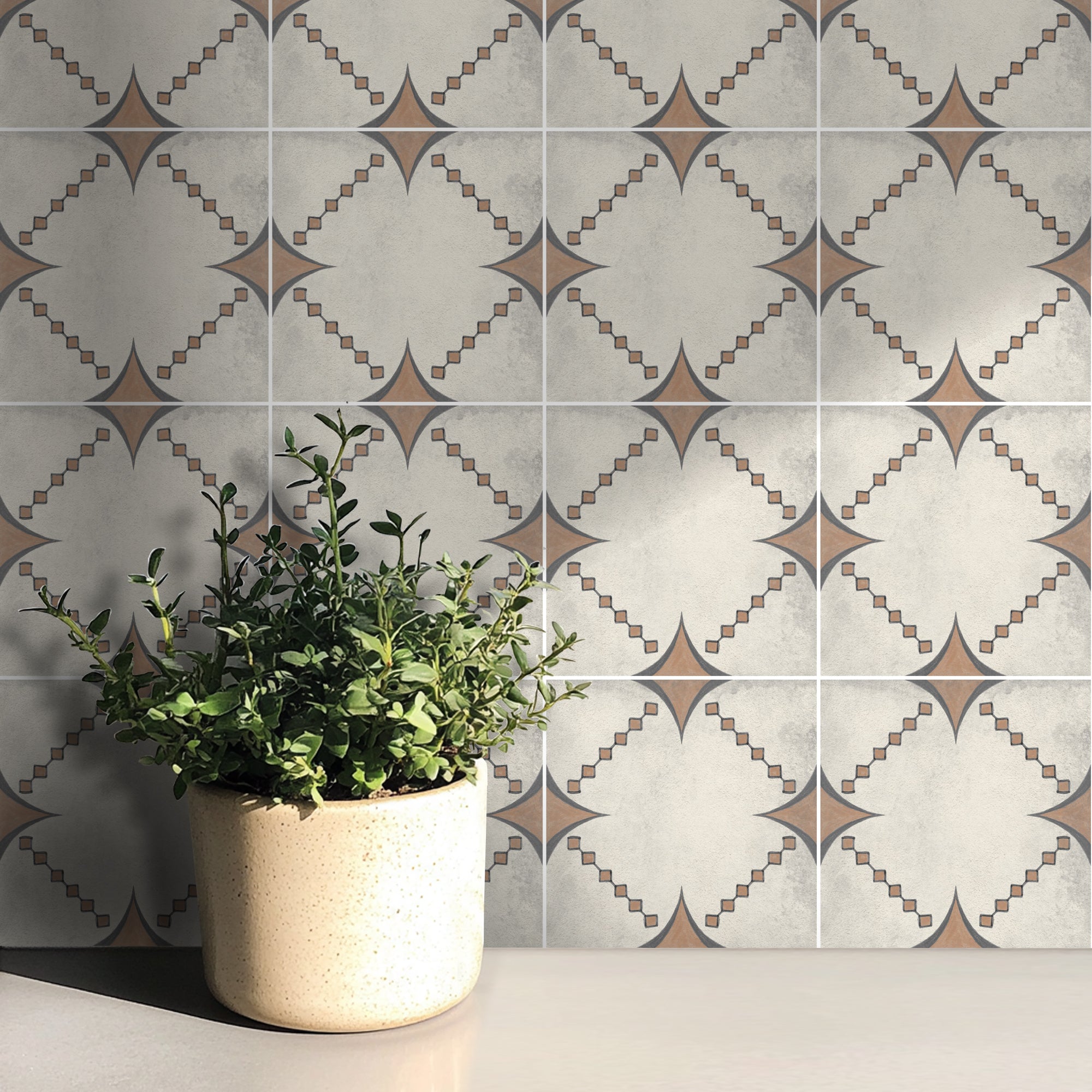 a potted plant sitting in front of a tiled wall