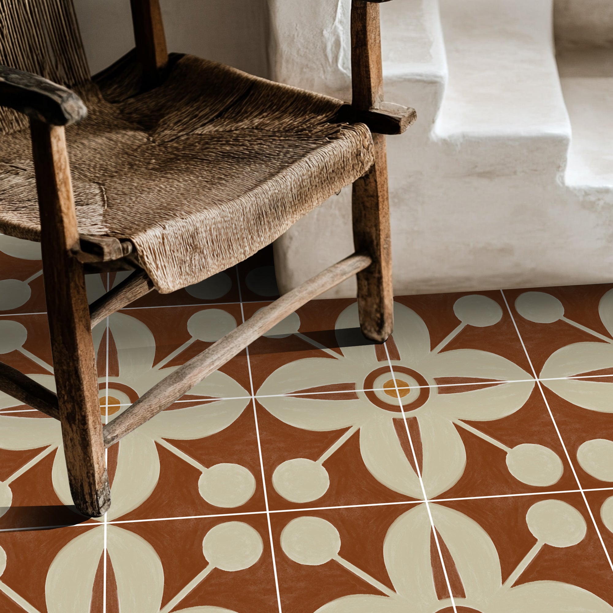 a wooden chair sitting on top of a tiled floor