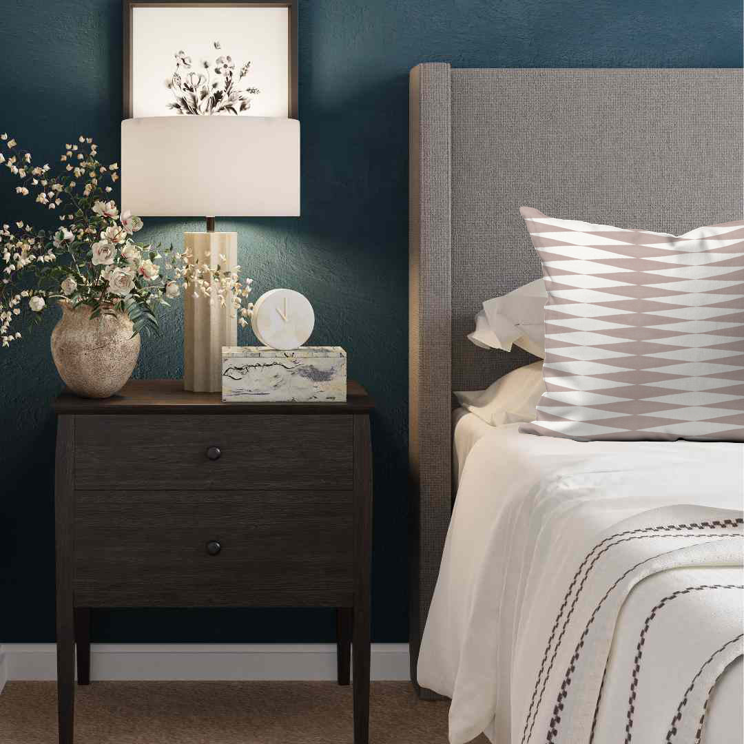 a bedroom with blue walls and a nightstand with flowers on it