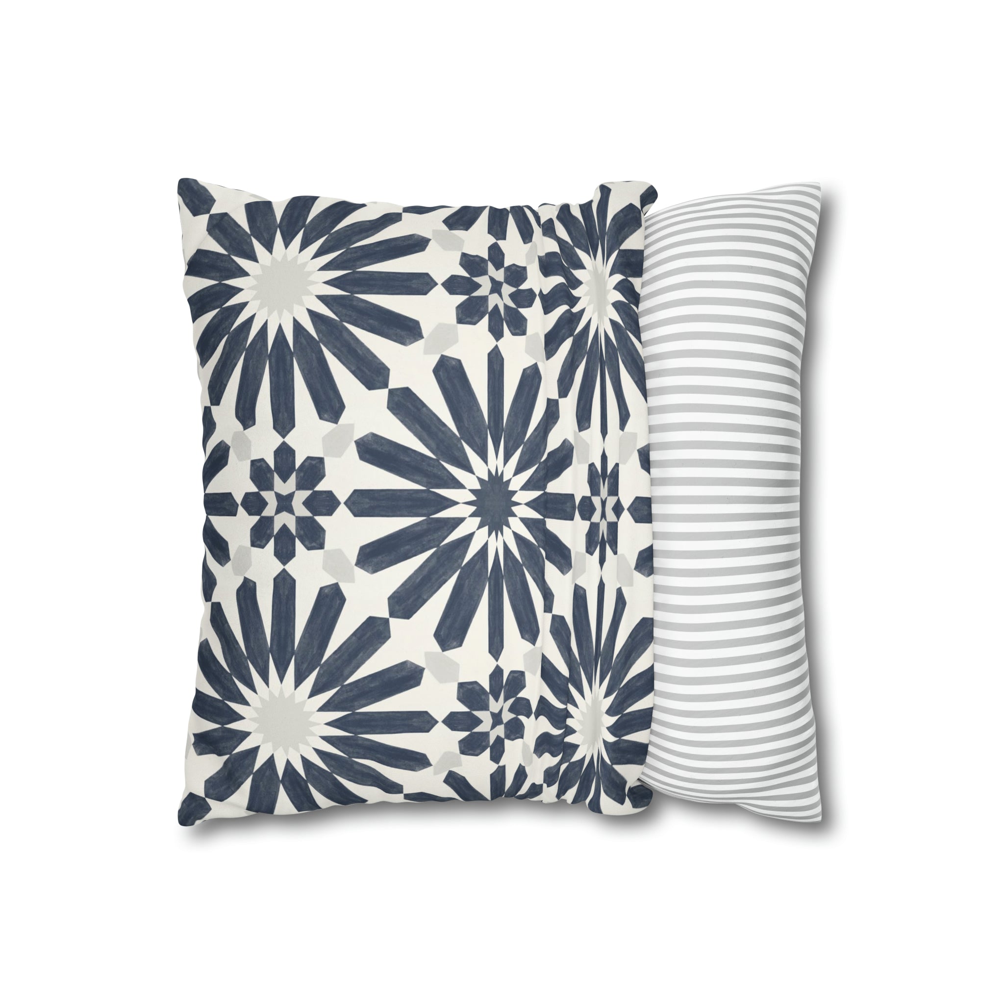 two blue and white pillows on a white background