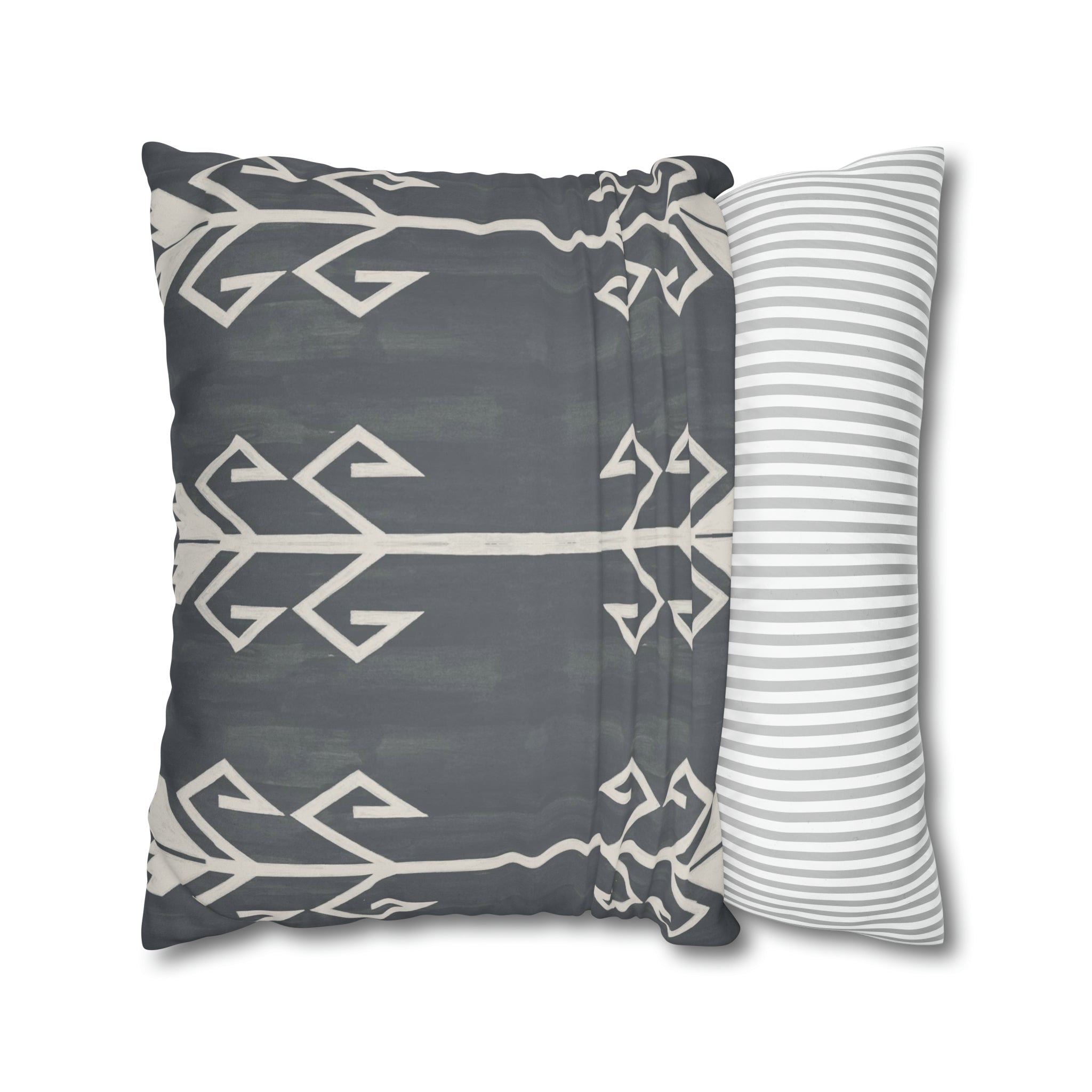 a gray and white pillow and a striped pillow