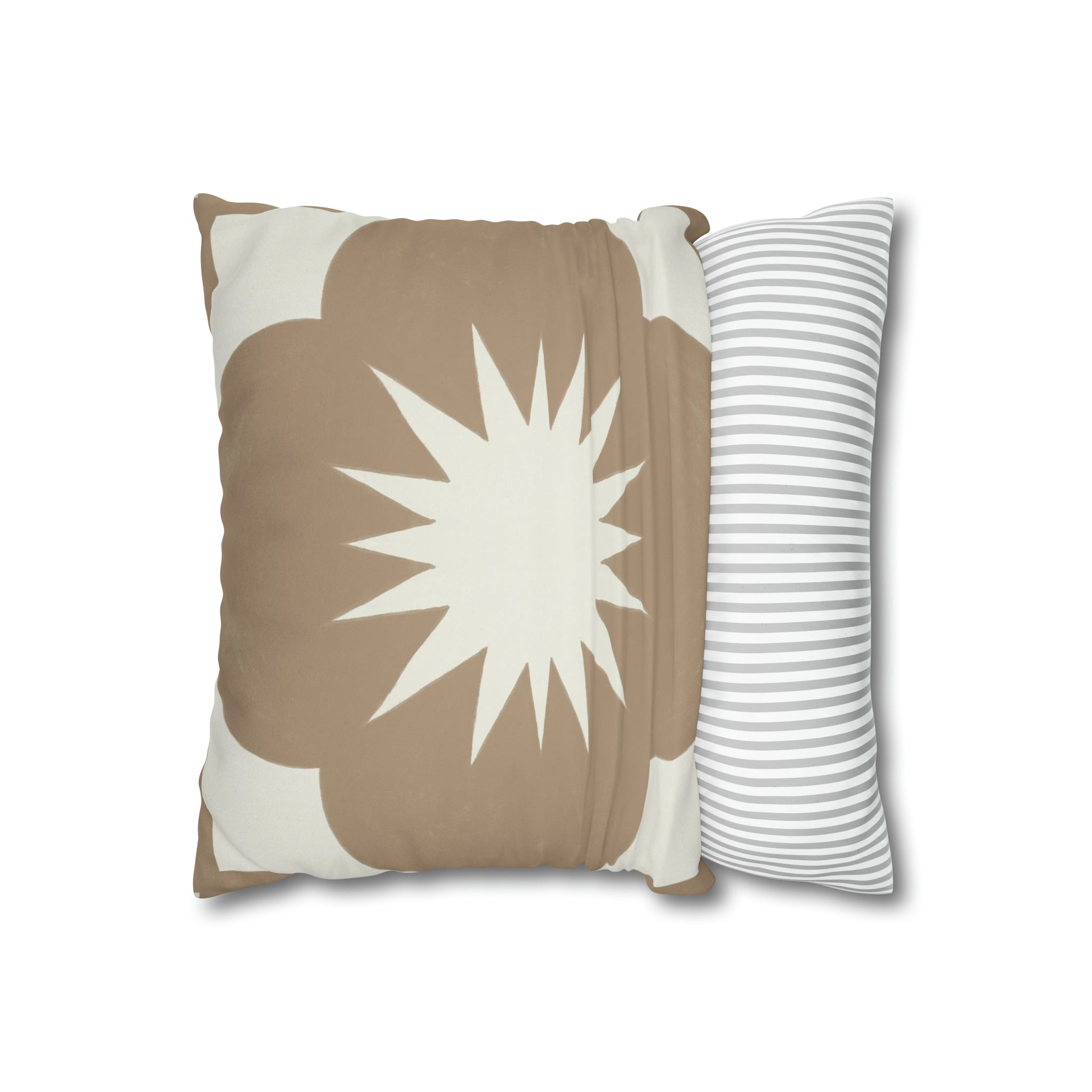 a brown and white pillow sitting next to a white and brown pillow