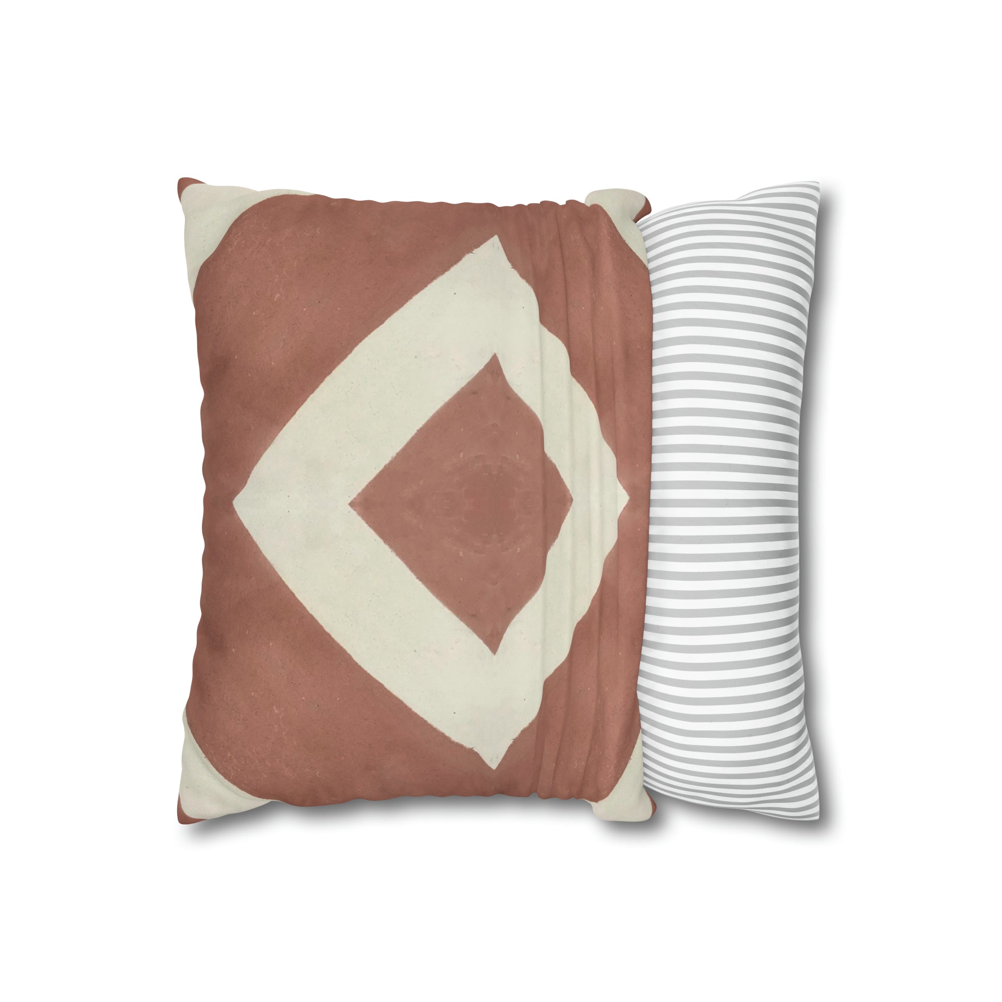 a brown and white pillow sitting next to a striped pillow